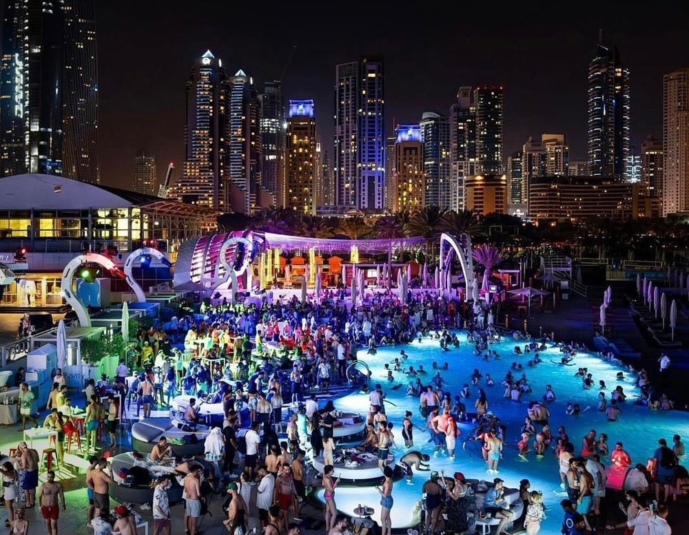Dubai is home to one of the most glamorous nightclubs on the planet, providing an unforgettable experience to its guests. The best clubs in Dubai compete with each other regarding infrastructure, interior design, hospitality, and atmosphere, pushing each other to the boundaries of perfection. In the past, people from Asia used to go to European countries or the United States to have authentic nightclub experiences, but now Dubai is the favourite of many Europeans and Americans in terms of nightlife. This shift in first choice has come after so many years of excellent service and improvement from those years of experience. 5 Best Clubs In Dubai Compiling the list for the best clubs in Dubai was not an easy task, but we did it for you and compared a long list of highly rated nightclubs from different viewpoints, and these are our top 5 picks for the best clubs in Dubai! 1. Sky 2.0 Sky 2.0 is one of the most famous establishments in Dubai. It would be a fraud to compile a list of the best clubs in Dubai and not add Sky 2.0. The club has so much to offer that it’s almost impossible to list all of its distinctive qualities. However, the most attractive bit is that it is a rooftop setting. Sky 2.0 took the leap and did something out of the box; they cashed out the jaw-dropping Dubai skyline, which means a rooftop setting where you can enjoy music, feel the cool desert breeze from the sea, and look at the engineering marvel of Dubai’s landscape. They worked a lot on the music systems, and even after being in an outdoor setting, you will easily feel the echo, the bass, and the electricness of the atmosphere like you do in a closed high-end nightclub. This month is Sky 2.0’s closing season, so you gotta check it out to enjoy some of the craziest nights of the year. Sky 2.0 is located at the Dubai Design District and opens from 10:30 p.m. till late at night. Don’t miss out on this amazing gem at any cost! 2. Ora Club Dubai Ora Club Dubai is the ultimate nightlife experience you can get in Dubai. The vibe is all Western, and you wouldn’t feel for a moment that this is in the Middle East. Perfectly built infrastructure, great music, lively atmosphere, and a terrific crowd, Ora Club Dubai checks all the boxes. Ora Club Dubai is also a playground for some of the best DJs in Dubai, amazing performers, and a very hospitable staff. All of them make sure that your visit justifies its worth and you come again and again as long as you’re in Dubai. Ora Club Dubai is located on the 44th floor of the Hilton Dubai, Al Habtoor City, Sheikh Zayed Road, Dubai. If you’re a fan of Afrobeats and Hip-hop, this May, they’re having The Urban Project event on Monday night from 11 p.m. onwards, so don’t miss out on that! 3. Avenue Club Dubai At no.3, we have the famous Avenue Club Dubai, famous for its vibrant vibe and sorta Grungy/futuristic theme. They’re one of the best clubs in Dubai and the first choice of a lot of youth and party-goers when it comes to nightclubs. Their drinks, shishas, and food are also quite well-reviewed, and the public opinion is that you can’t afford to miss it. The best part is that the staff is very friendly, and the service they provide from the moment you enter till the moment you leave is truly appreciable. They really make sure that you have a really nice time. Avenue Club Dubai has also quite improved and evolved with time, and the kind of establishment that never hesitates to try something new and incredible. They’re located at the 42nd level of the famous Shangri-La Hotel, Dubai, UAE. We recommend that you visit their May 2025 special event nights, “Bad Habits,” every Wednesday, from 11 p.m. to 4 a.m. 4. Papa Club Papa Club is on this list because it checks all the boxes that we discussed earlier. We talked about the distinctive qualities of 3 different clubs before it but Papa Club offers an experience which combines those qualities. Whether it is the infrastructure, the modernity of the place or the quality and range of food and beverages they’re offering, Papa Club offers all of that with the best possible quality and also under one roof. That is why it still rules the heart of many regular nightclub visitors of Dubai. Papa Club is located 3rd Floor, V Hotel, Dubai. Ladies and couples also get free entry before 12 a.m., and gents are allowed to enter with an entry of just 150 AED, which will also give them a free drink. This May every Thursday night “Code Black” event is happening, so if you’re in Dubai and looking for the best clubs in Dubai, do check it out! 5. Ce La Vi Dubai If you love nice ambiance, want a place with great food and music, and also a nightclub experience, then look no further than Ce La Vi Dubai, my friend! It has all the mentioned qualities and a thousand more in actuality, it's which you’ll find out on your visit. It is located on the 54th level of the Address Sky View Hotel, Downtown, Dubai. Make sure to book your tables as it gets packed and sold out very quickly. And yes, don’t miss out the “She’s With Us” event, happening exclusively this month on every Saturday from 9 a.m. to 3 p.m. Conclusion This was our list for the top 5 positions in the best clubs in Dubai. This list was curated after a long and thorough analysis of multiple famous nightclubs, and picking out the underrated ones that deserve true appreciation and business. Make sure to visit these places whenever you plan to visit Dubai!